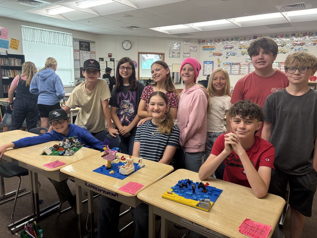 students smiling with lego