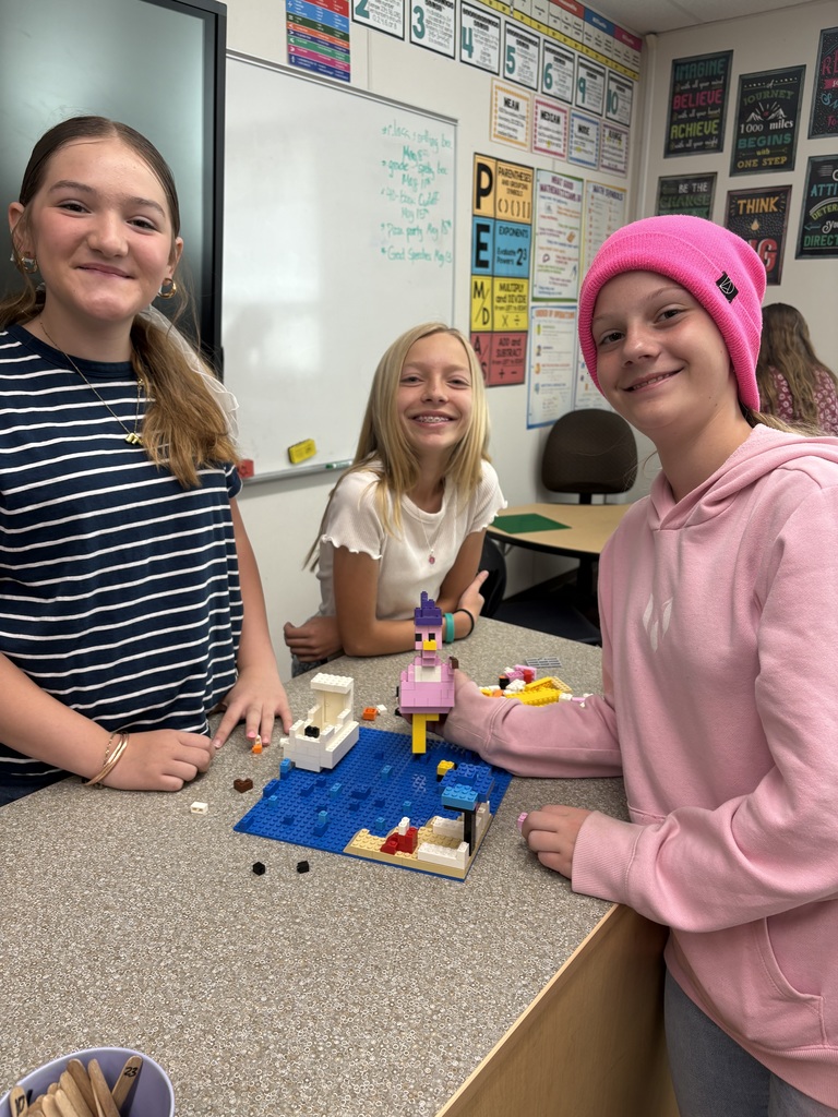 students smiling with lego