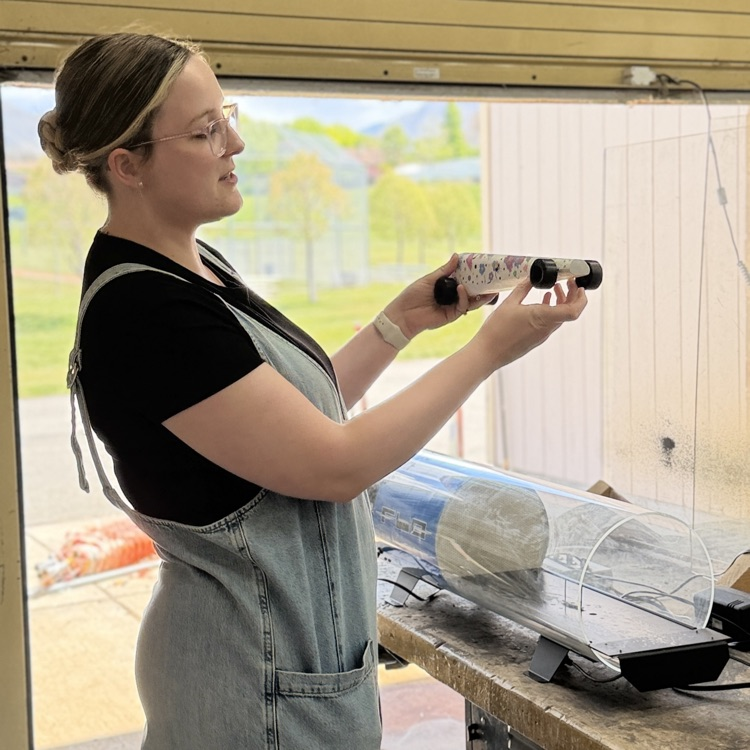 Ms. Ross checks out a student’s project  