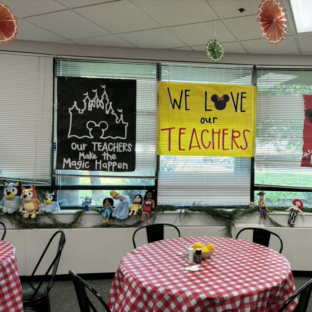 faculty room decorated with checkered table cloths and signs that say Our teachers make the magic happen and We love our teachers!