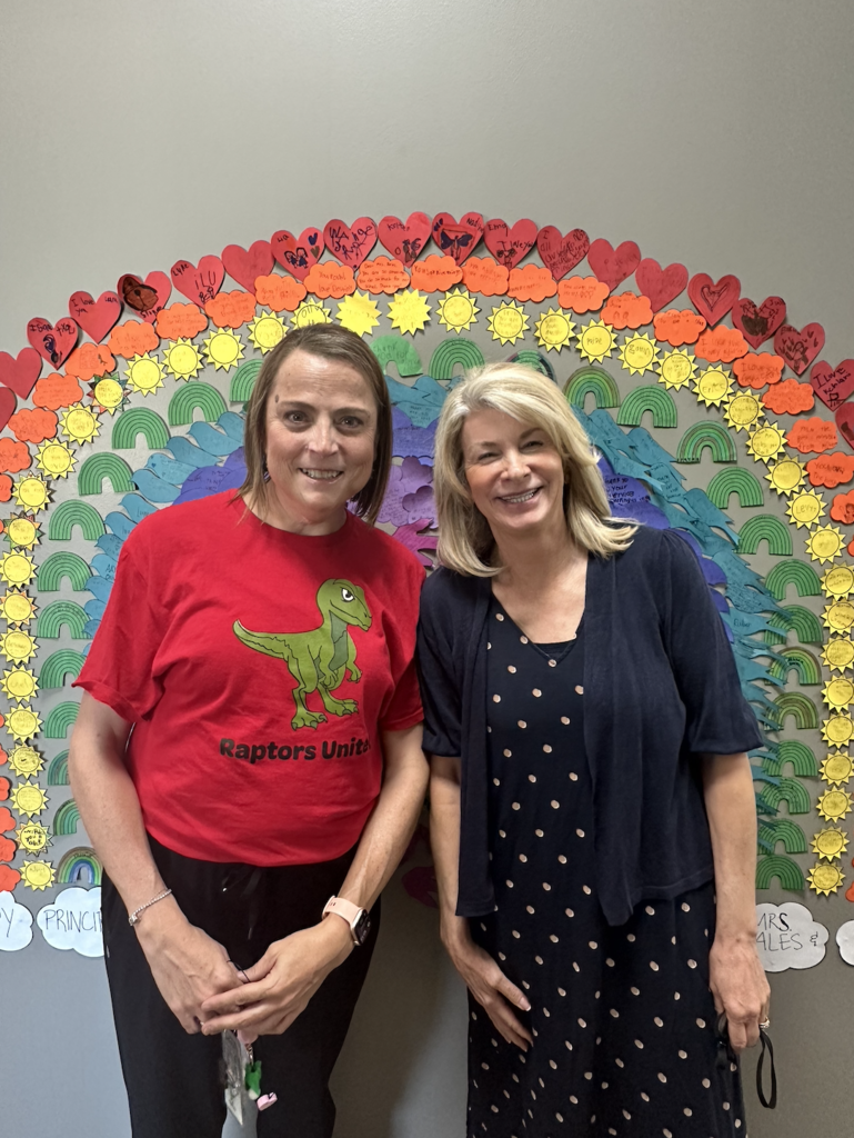 Our principal, Mrs. Hales and administrative intern, Ms. Mangum standing and smiling in front of the rainbow that was made by students.