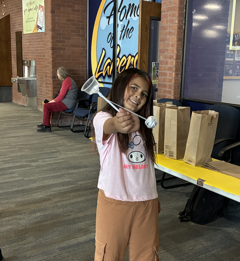 a student showing off her creation