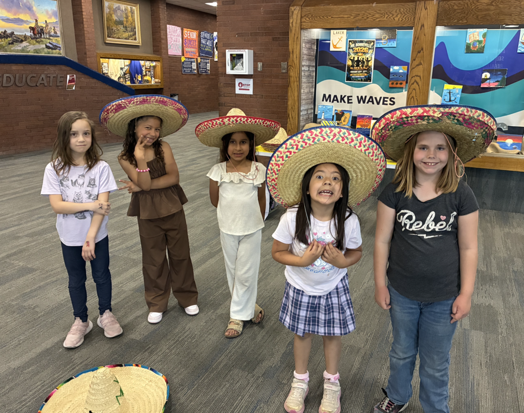 a group of 2nd grade girls wear sombreros