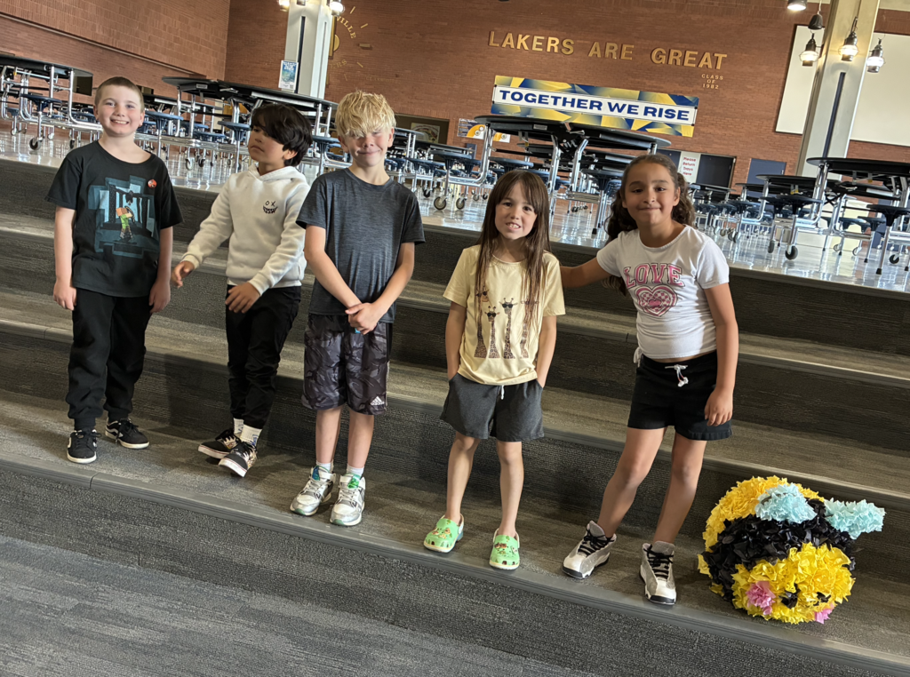 2nd graders posing with a pinata