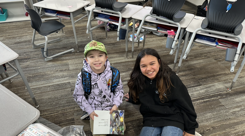 a first grader and a 4th grader reading together