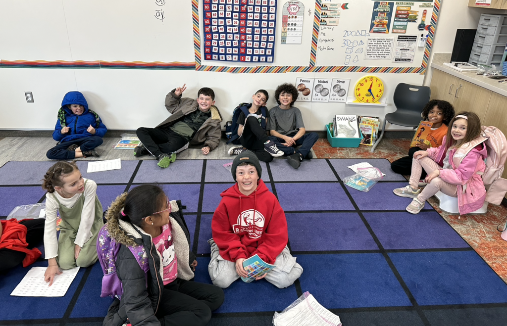 first graders and 4th graders reading together