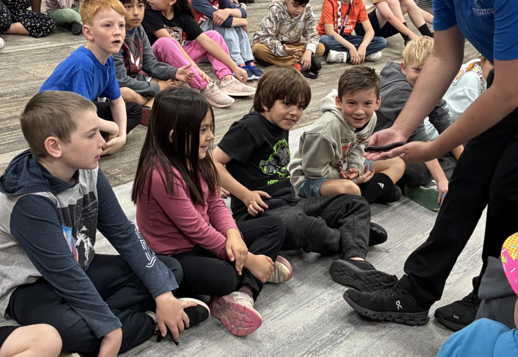 2nd grade students being shown a centipede from the rainforest