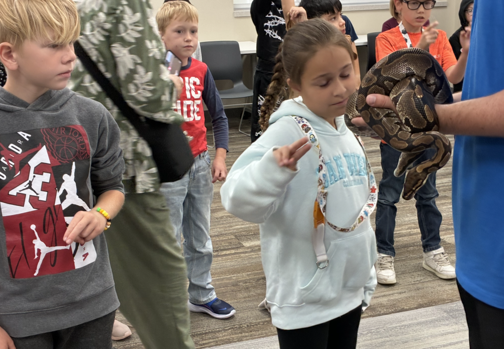 a student petting a snake