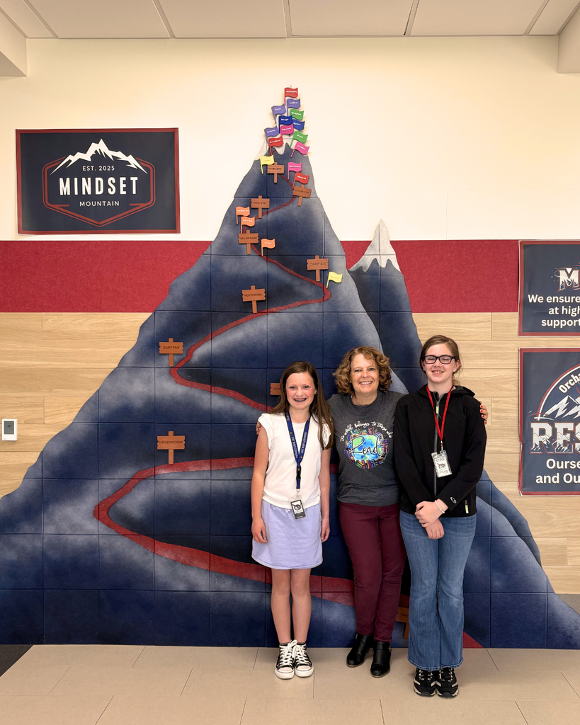 Student smiling in a photo with Jennifer Nielsen. 