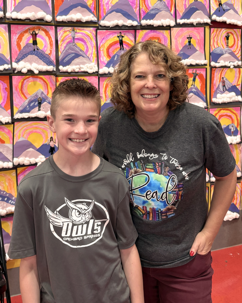Student smiling in a photo with Jennifer Nielsen. 