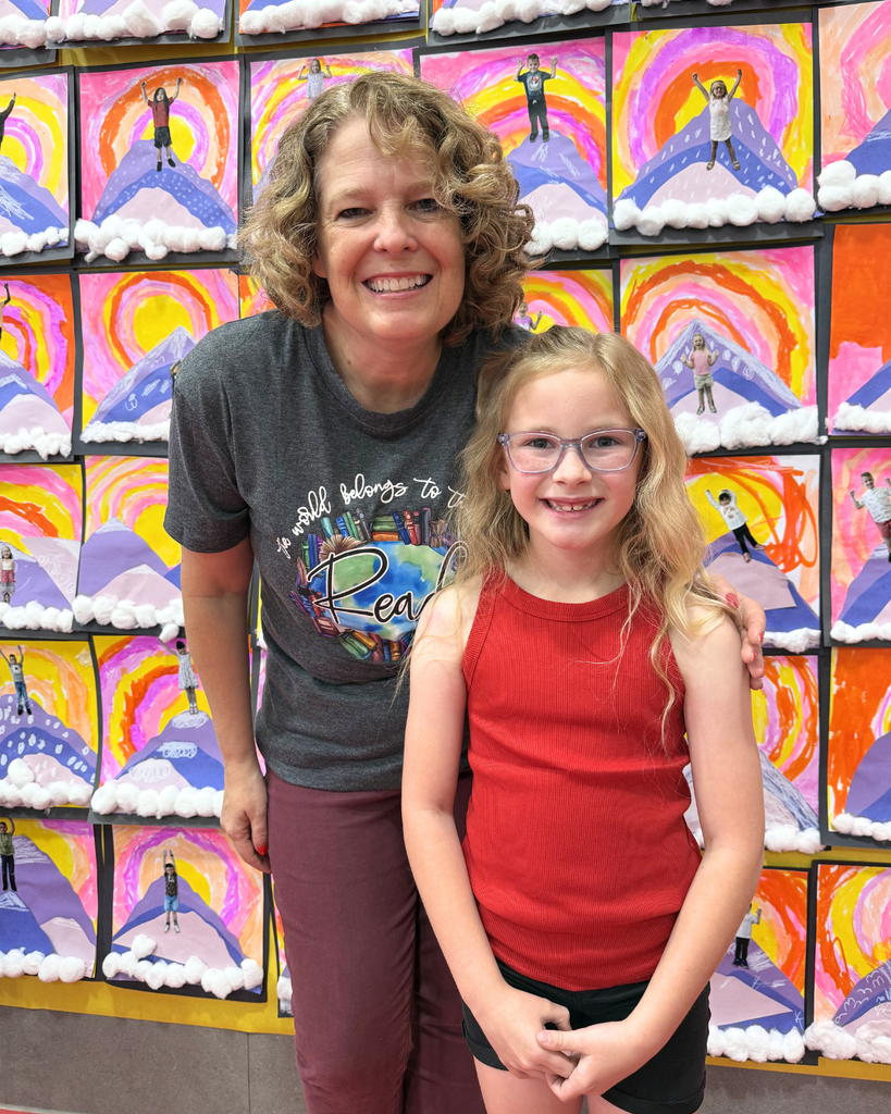 Student smiling in a photo with Jennifer Nielsen. 