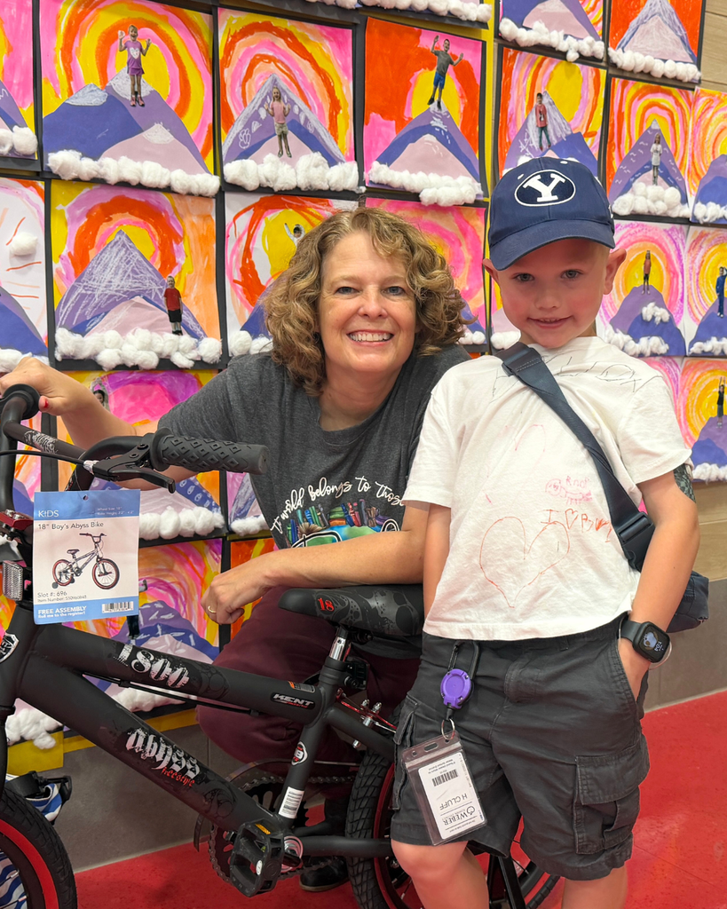Student with bike and Jennifer Nielsen.