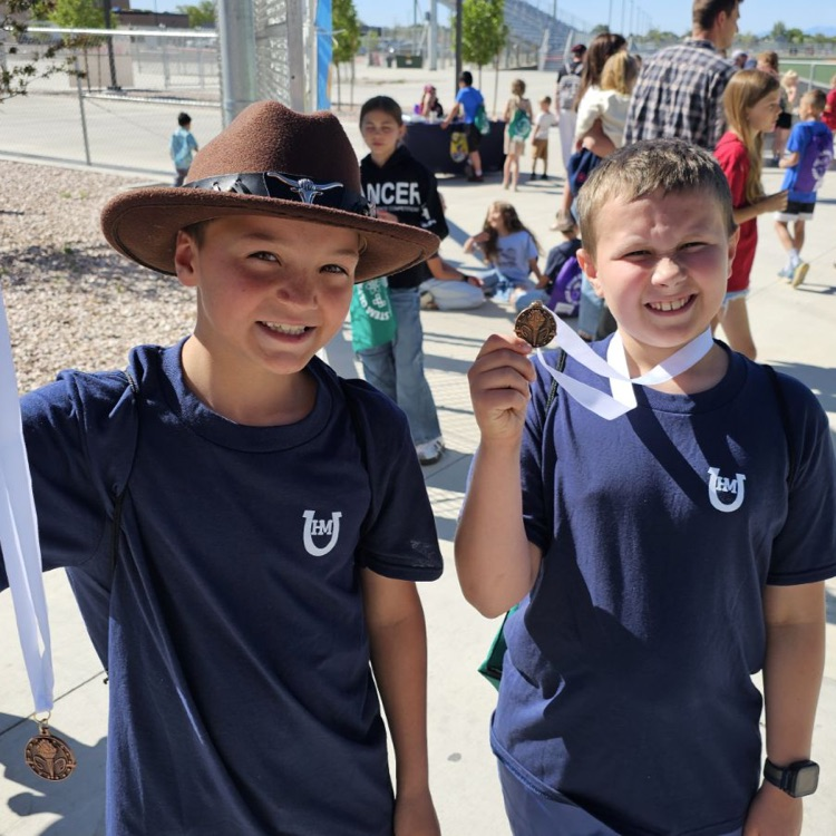 two students showing medals