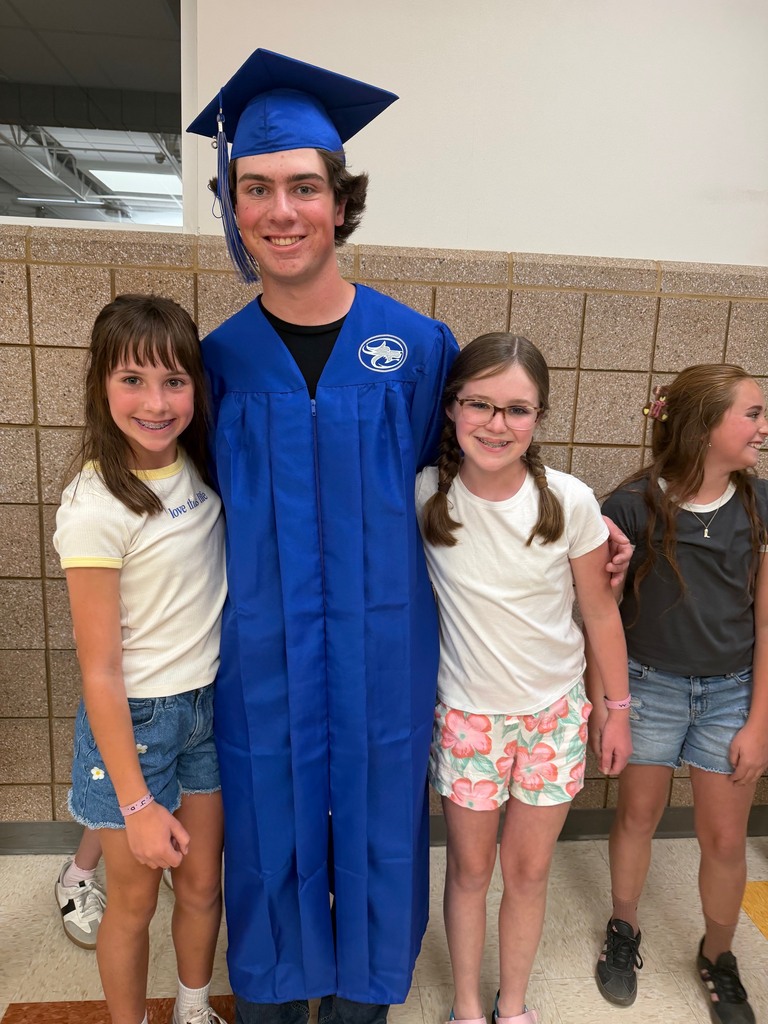 students smiling with a graduate