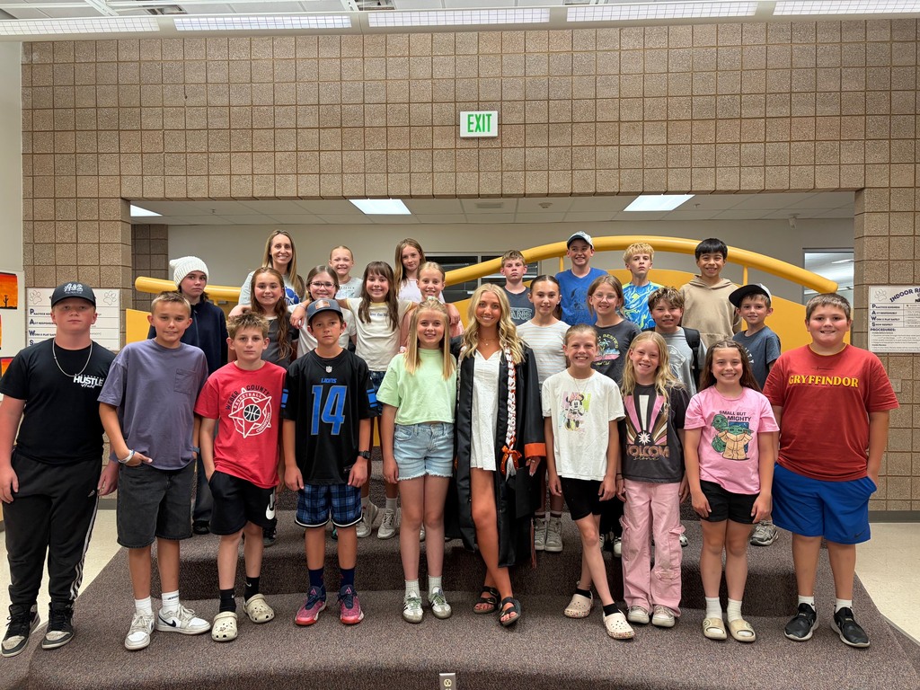 students smiling with a graduate student