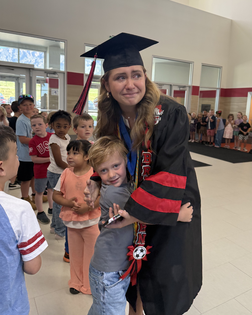 Graduate hugging a sibling
