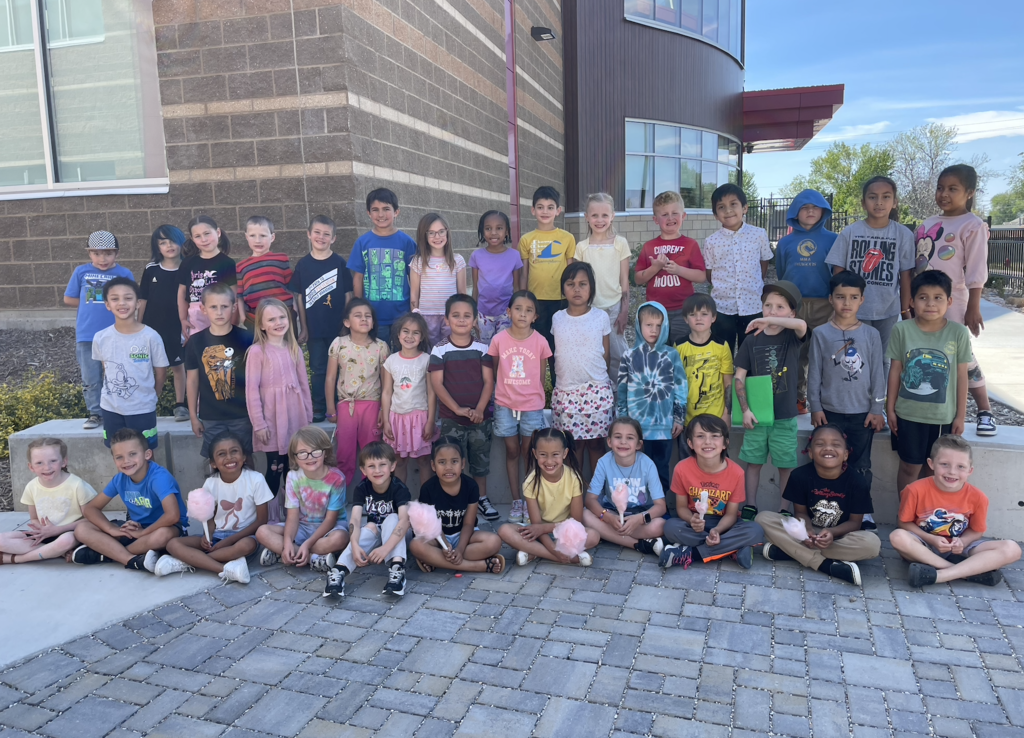 the entire group of first grade students all posing for a picture