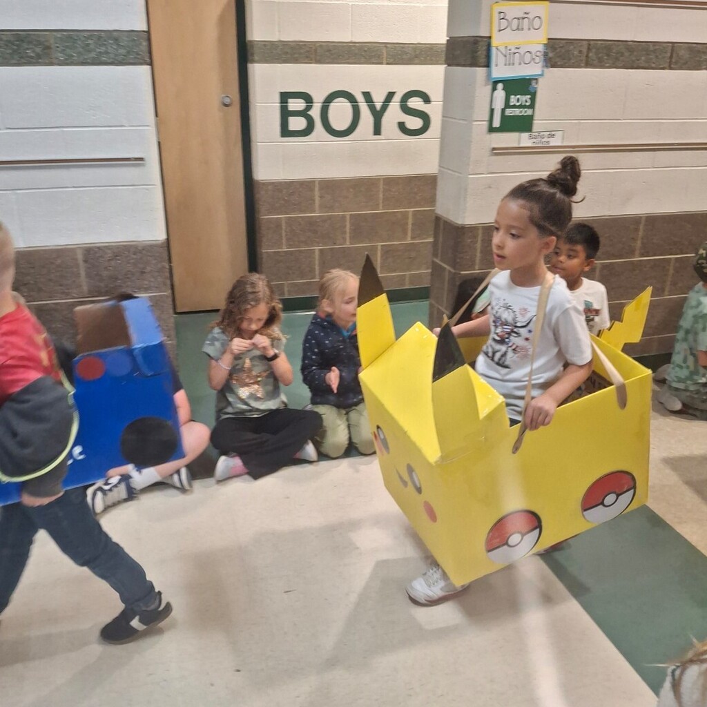 girl in yellow cardboard car
