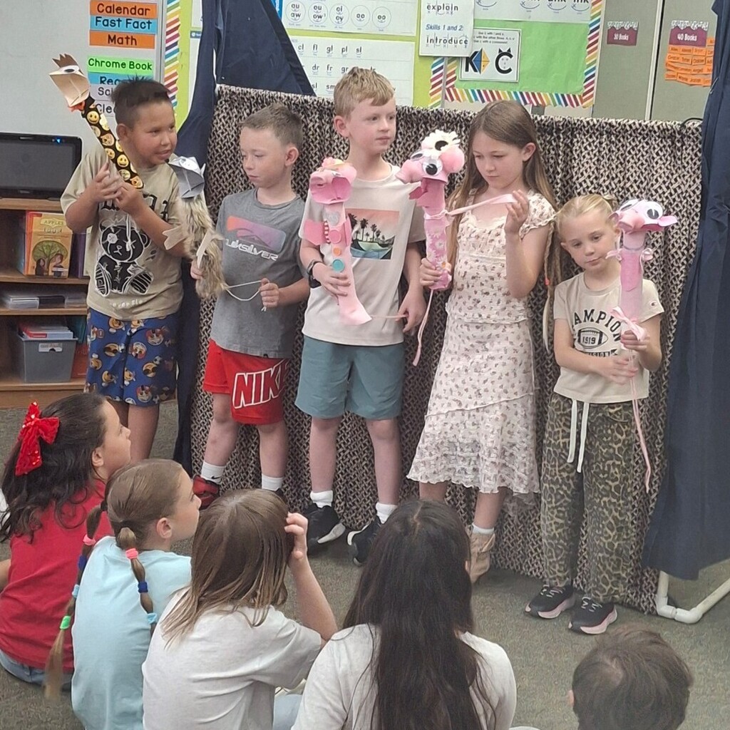 Kids holding their puppets