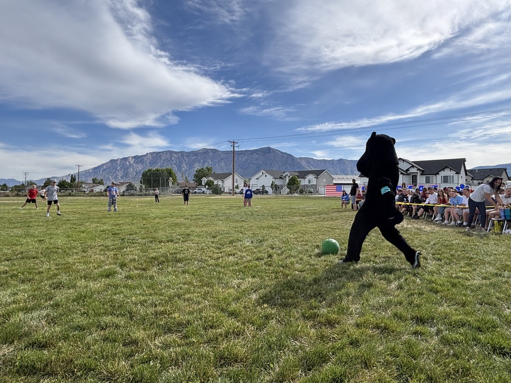Teachers and sixth grade students playing kickball