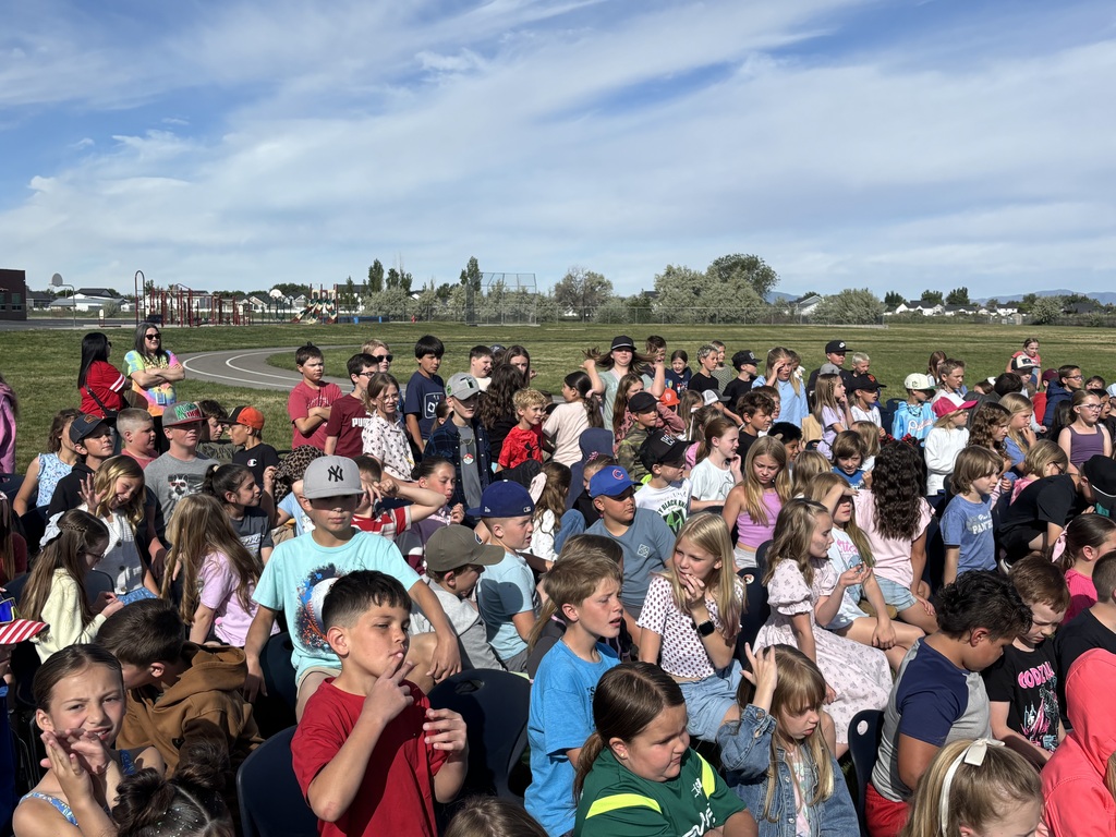 Teachers and sixth grade students playing kickball