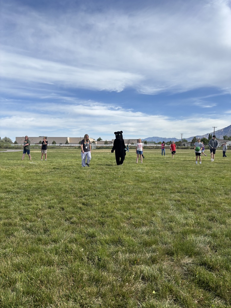 Teachers and sixth grade students playing kickball