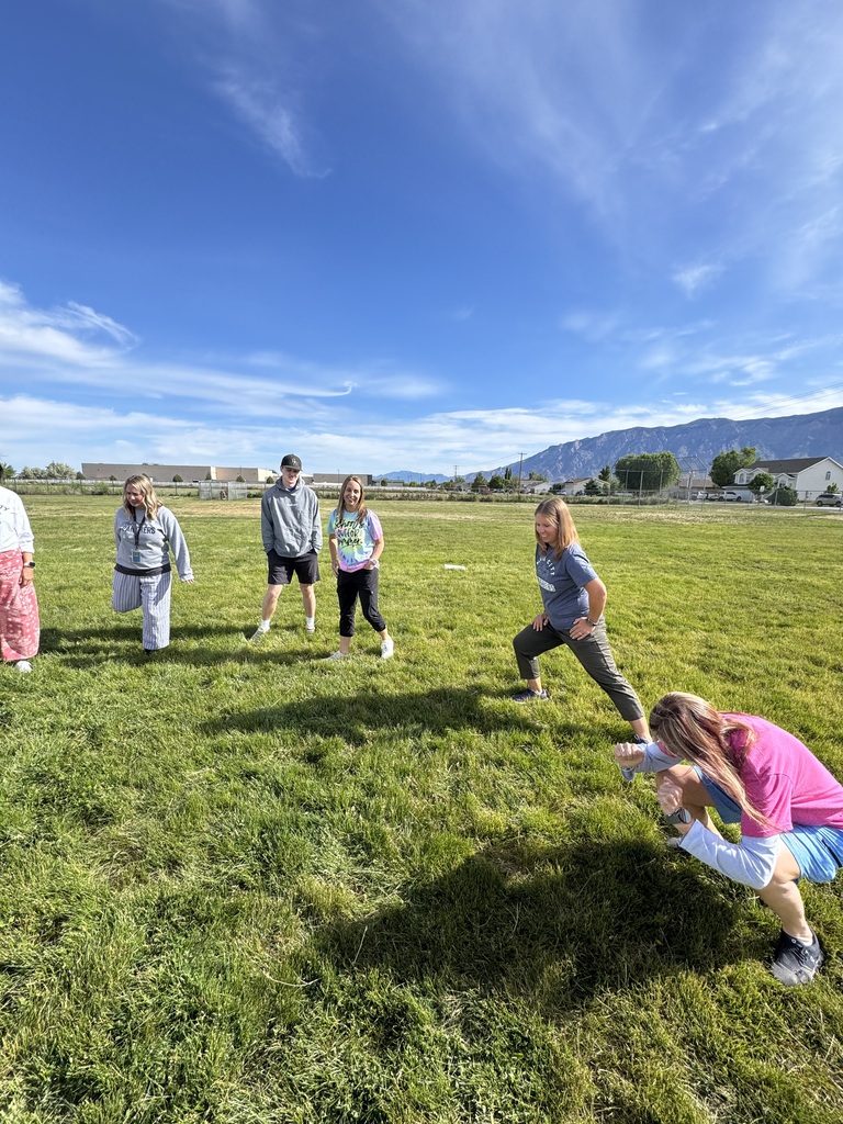 Teachers and sixth grade students playing kickball