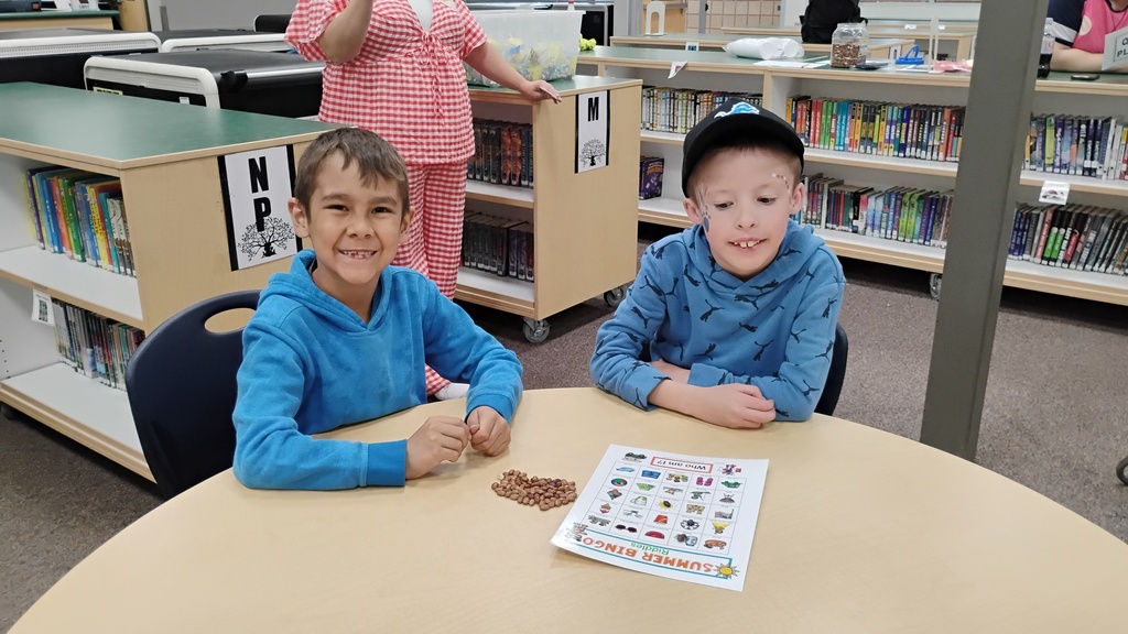 Students smiling playing Bingo on Field Day, with cute face paint