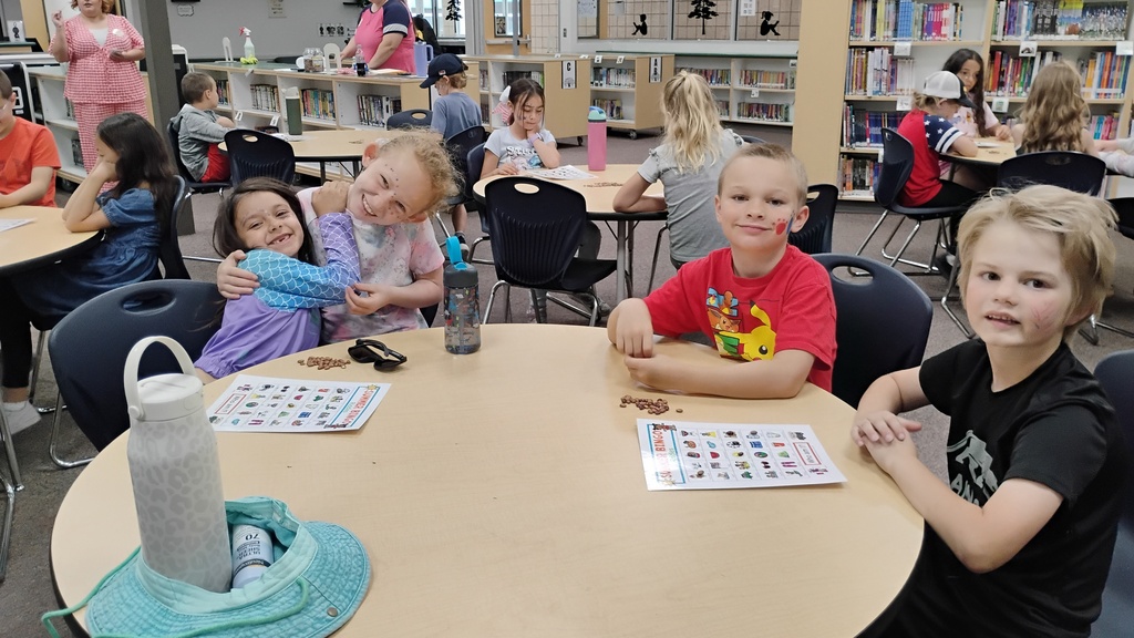 Students smiling playing Bingo on Field Day, with cute face paint