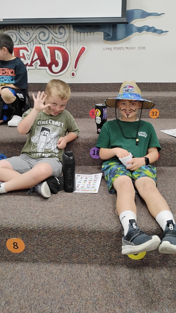 Students smiling playing Bingo on Field Day, with cute face paint
