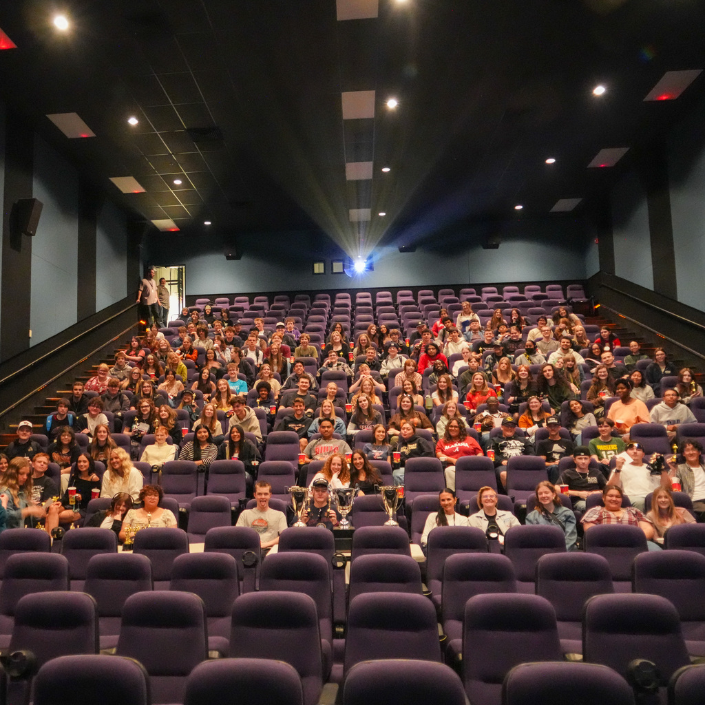 A theater full of students watching the screen