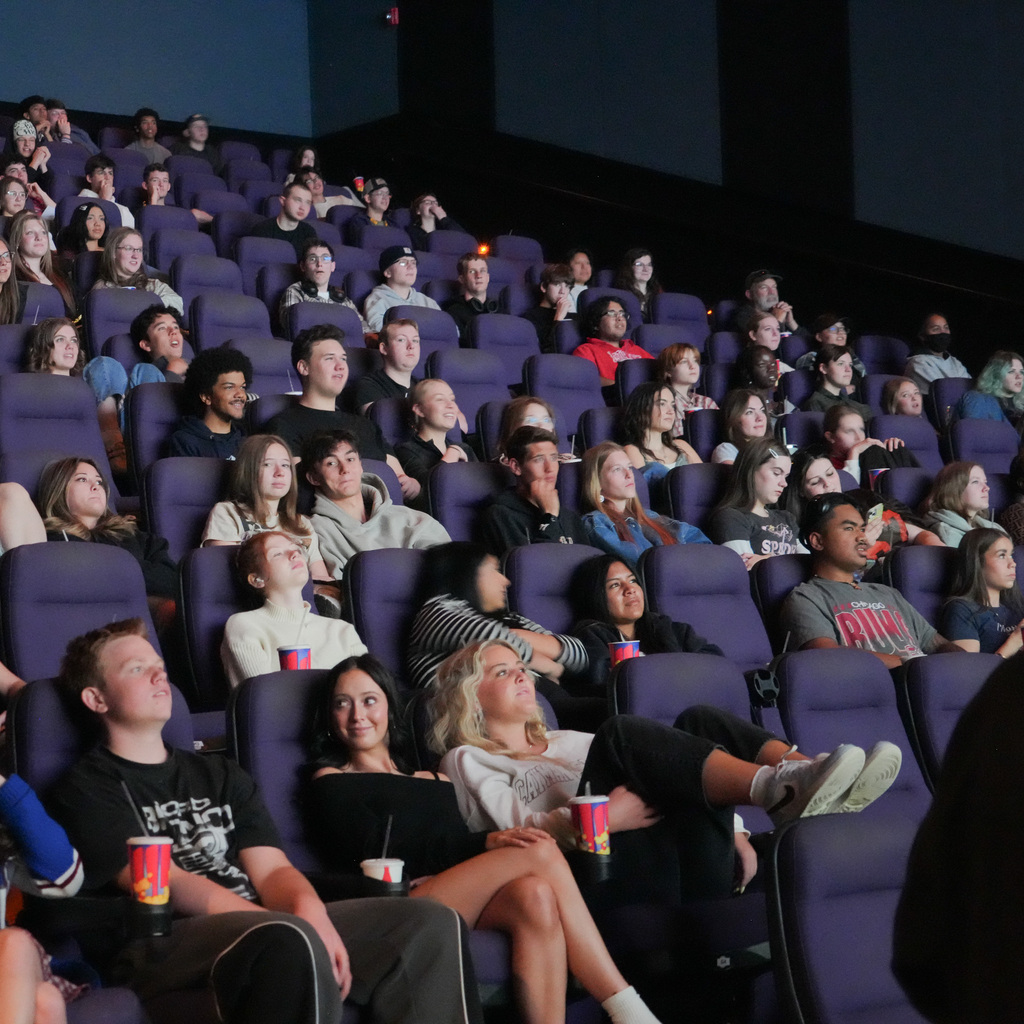 A theater full of students watching the screen