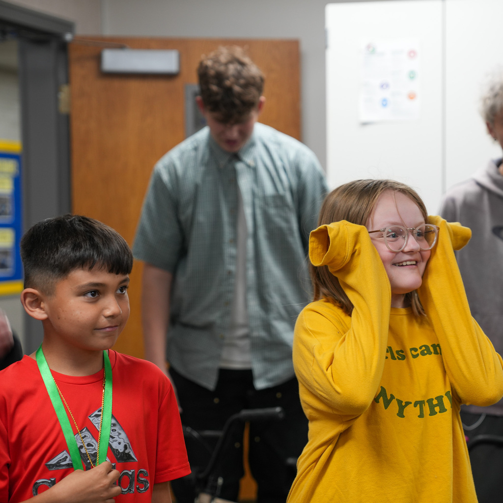 Two students look on excitedly