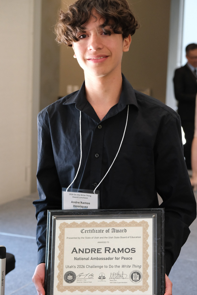 Andre standing holding the award