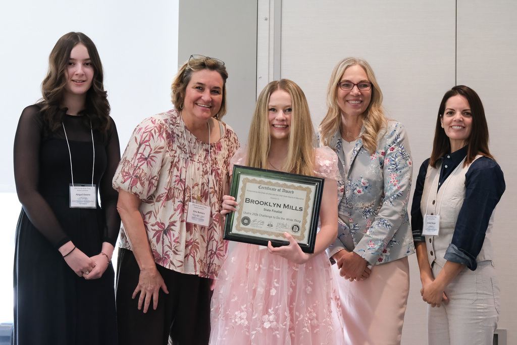 Brooklyn holding her award with supporters