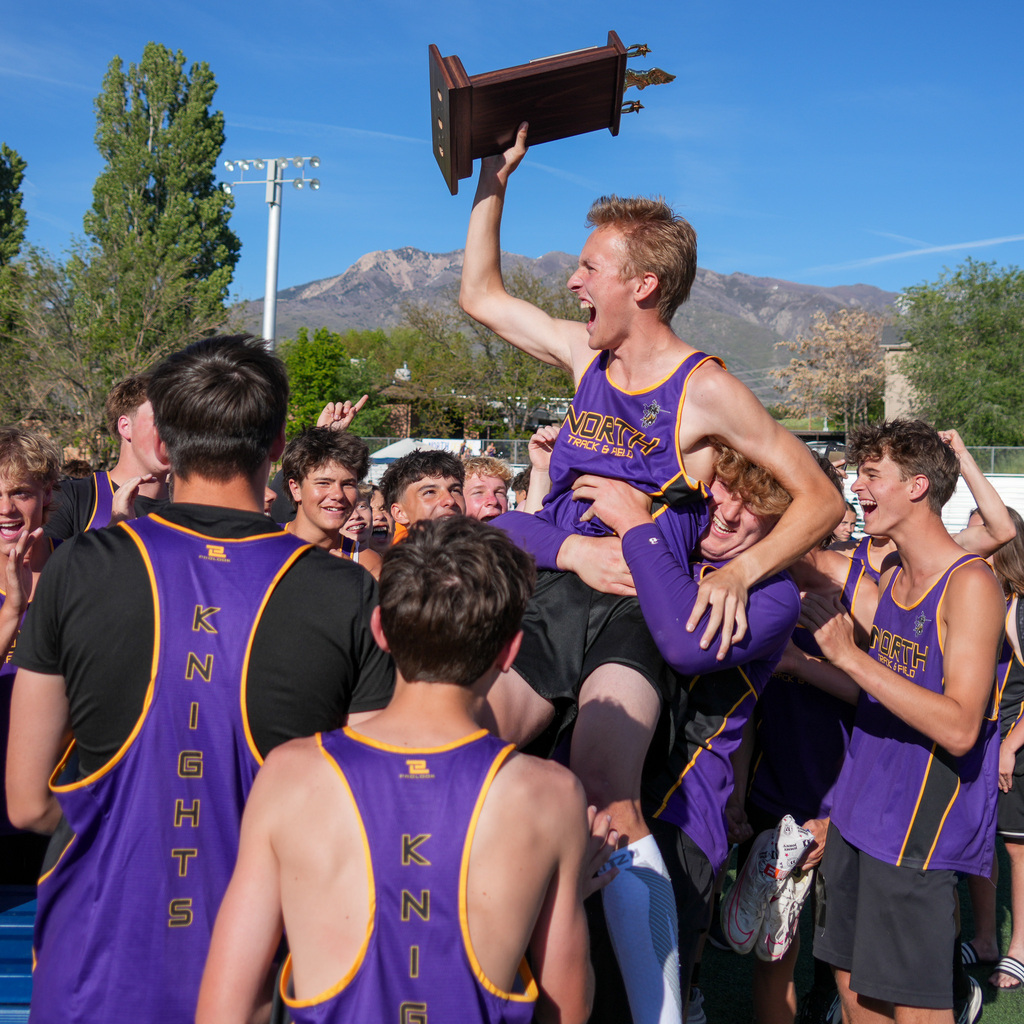 North Ogden boys hoist an athlete on shoulders while he holds the trophy above his head