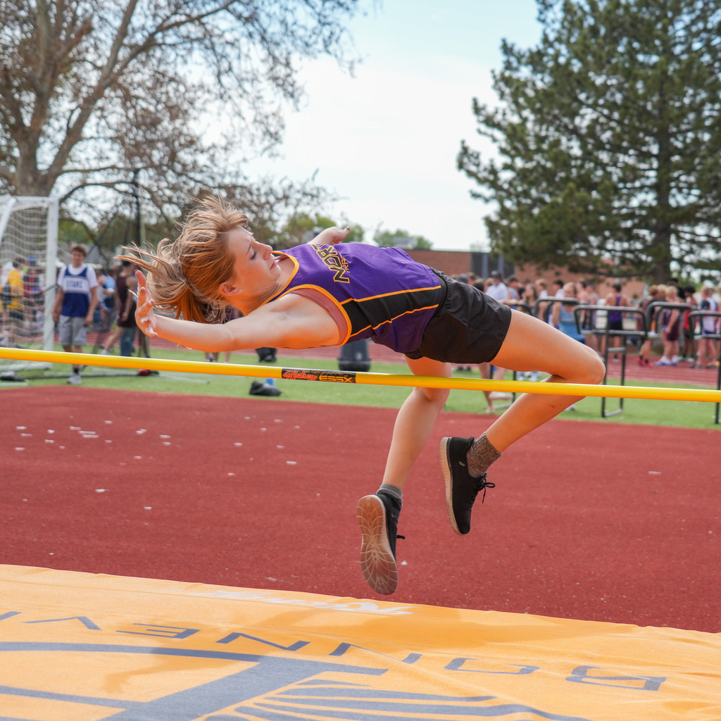 A North Ogden girl's track athlete jumps over the high jump bar