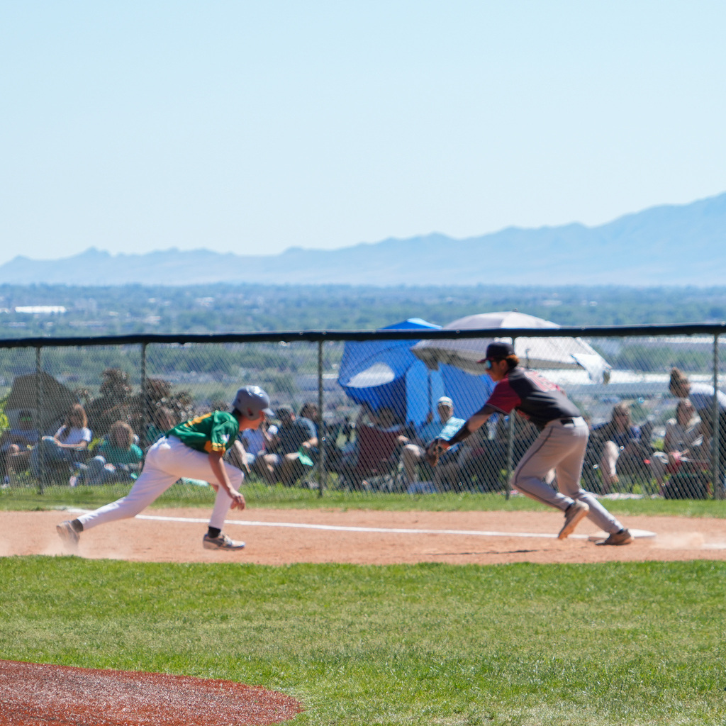 A rocky player attempts to get a wahlquist player out at the base