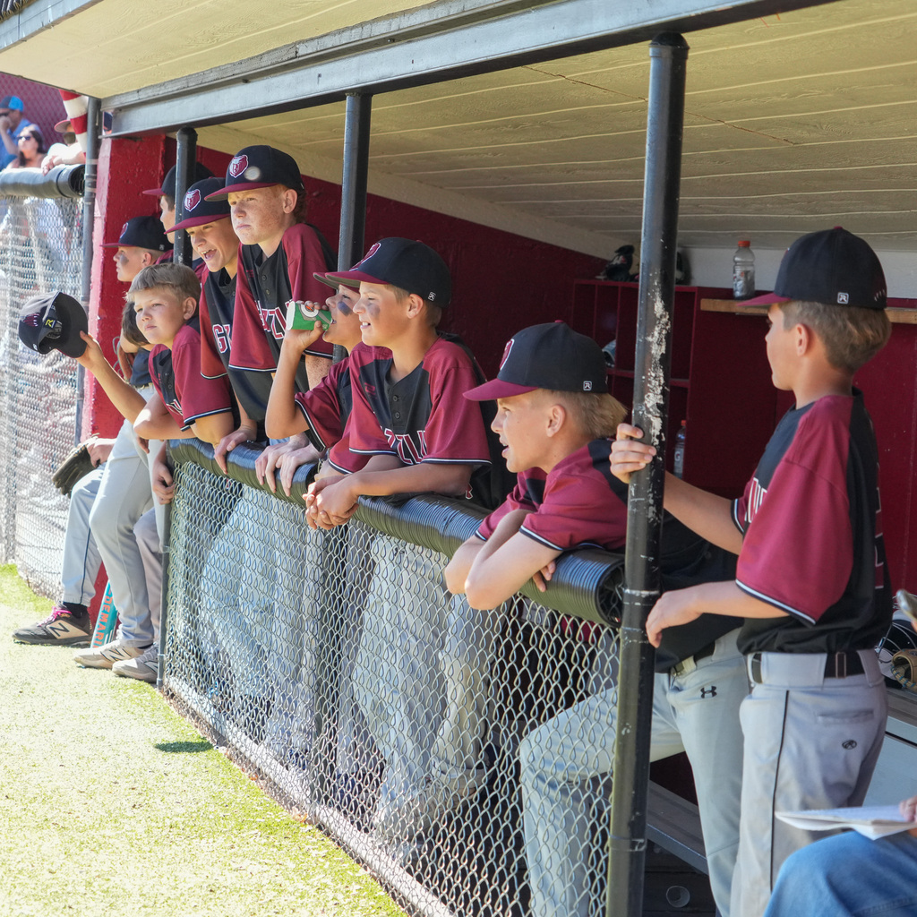 A shot of the rocky dugout with players looking out to the field