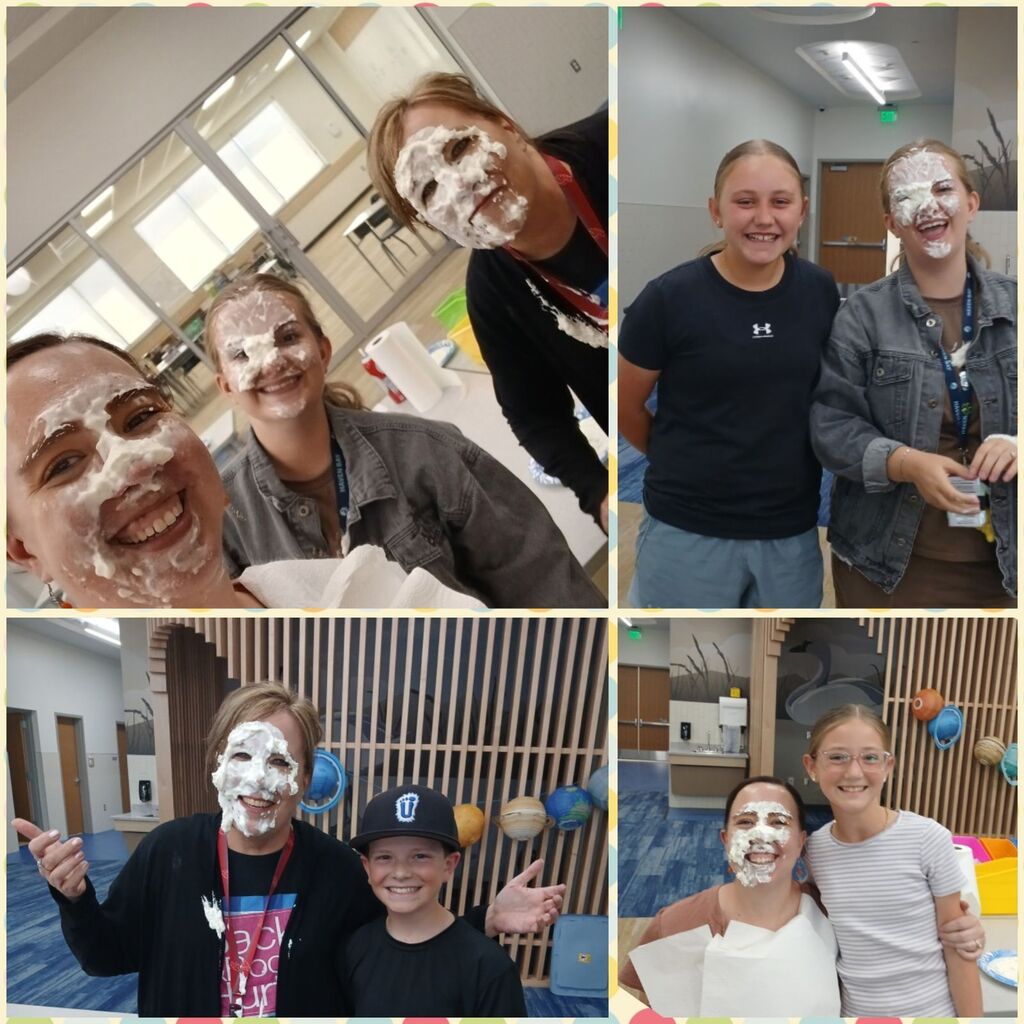 Three females smiling close to the camera with whipped cream on their faces. A roll of paper towels is on a table behind them.