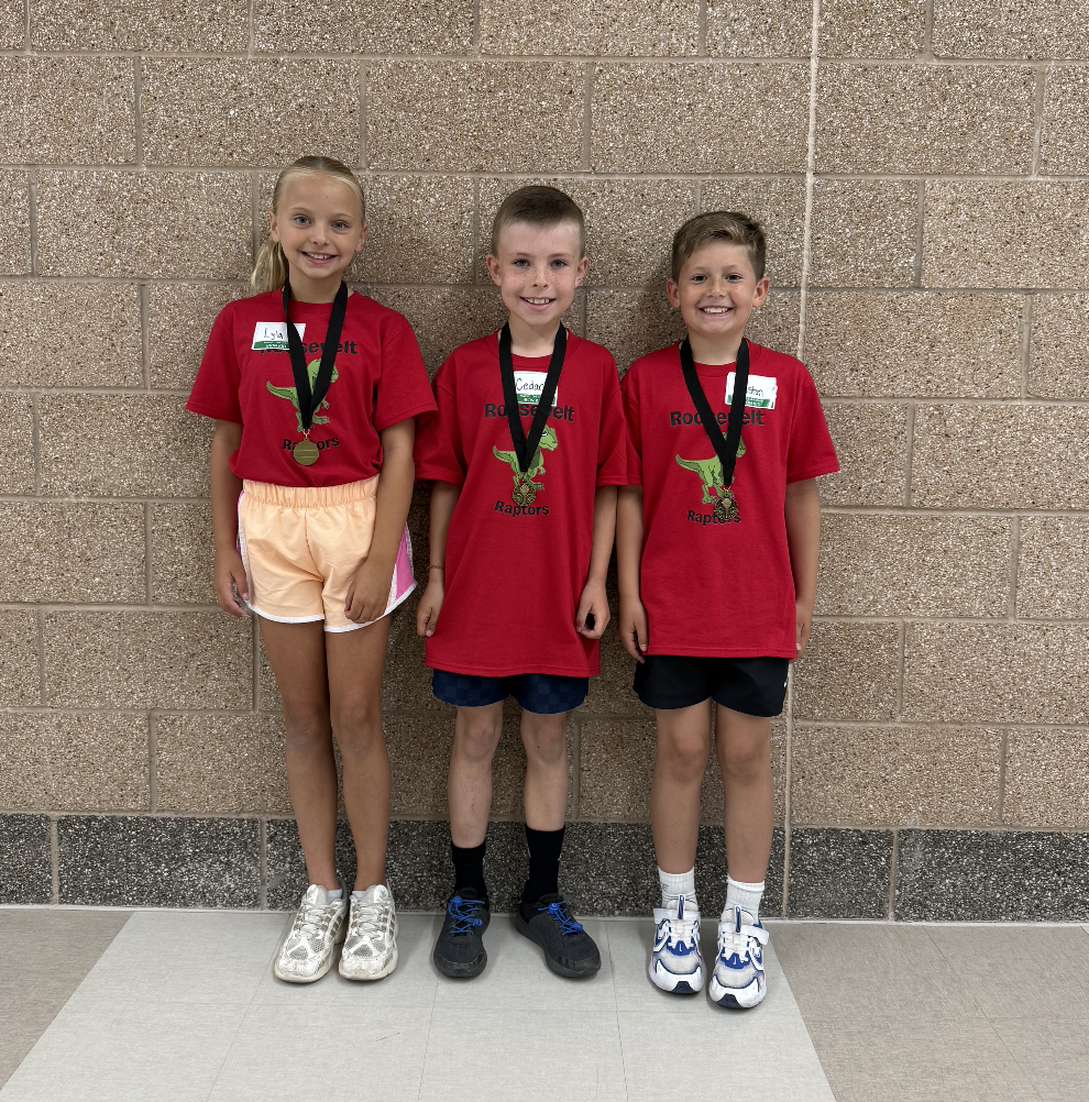 3rd grade iron kid team standing together showing their medals