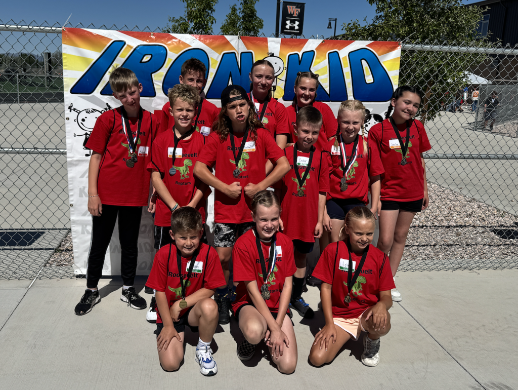 all roosevelt students who competed in the iron kid tournament standing in front of the iron kid banner