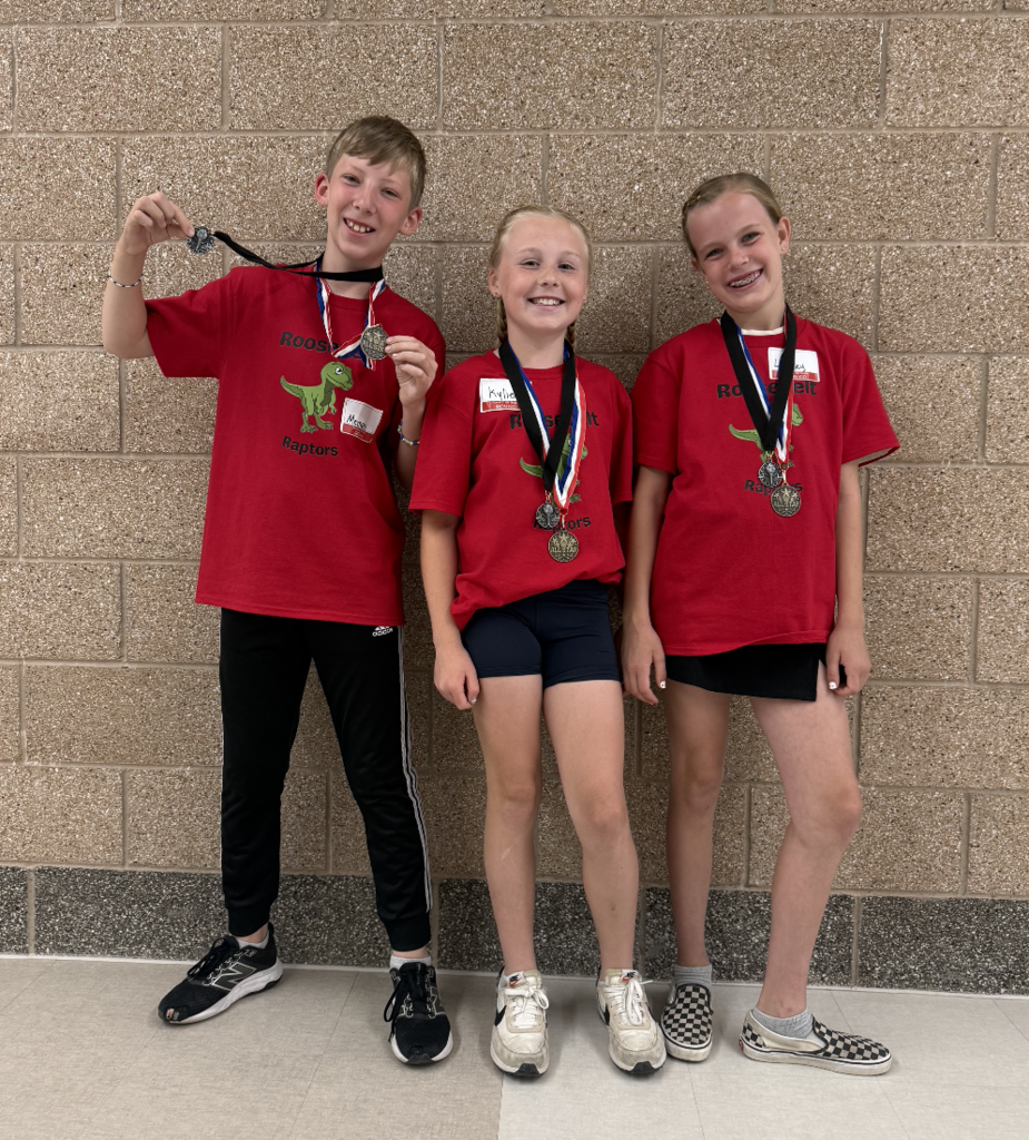 4th grade iron kid team standing together showing their medals