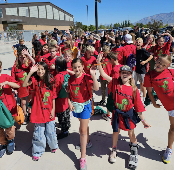 group of students at the STEM olympiad waving together as a group
