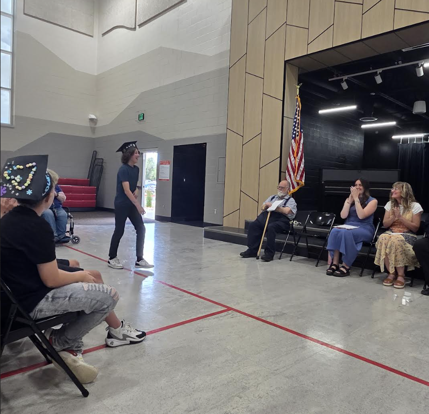 student walking up to be celebrated during the 6th grade graduation