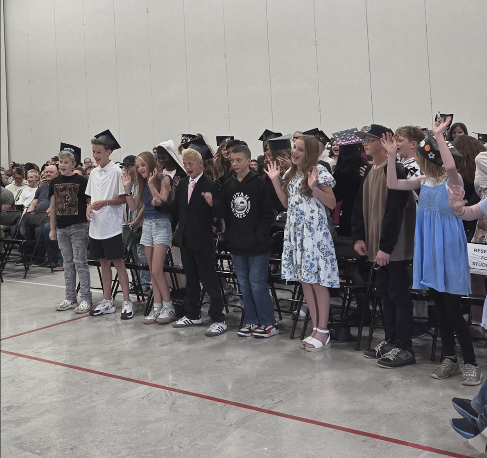 group of graduating 6th grade students cheering