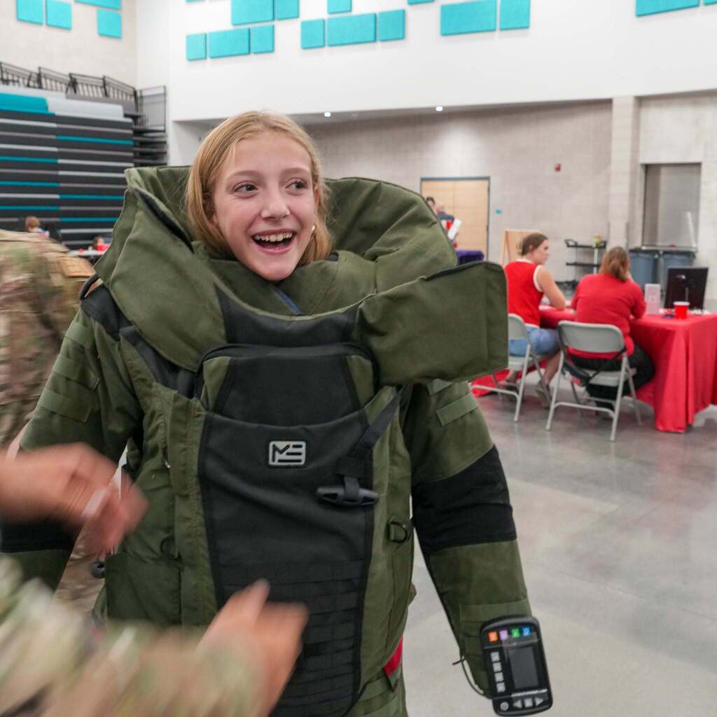A child trying on the bomb unit gear.