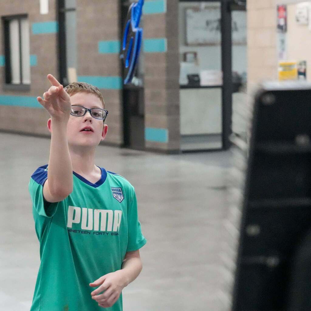 A young man playing a throwing game.