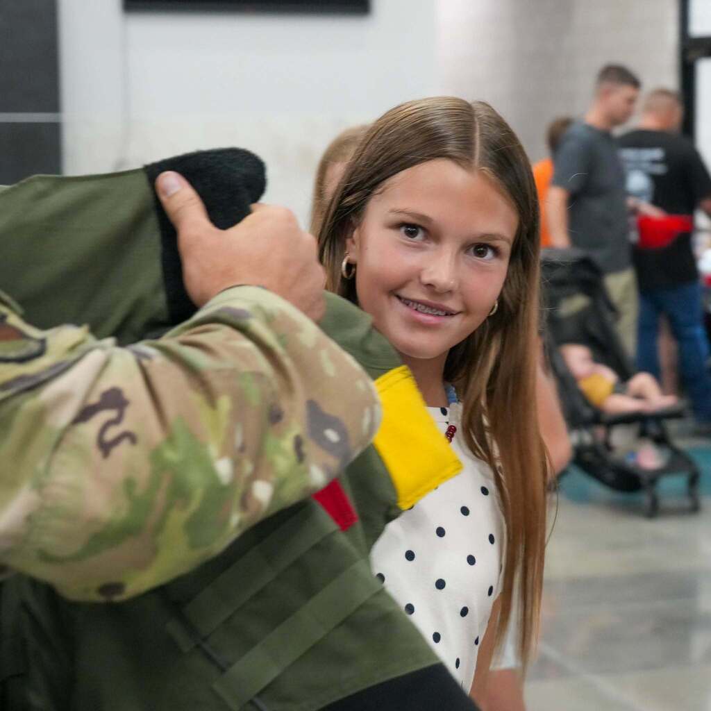 A child trying on the bomb unit gear.