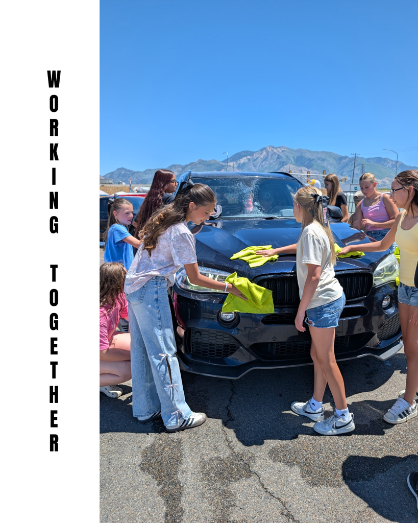 photograph of roy jr leadership working at the carwash fundraiser, 'working together'